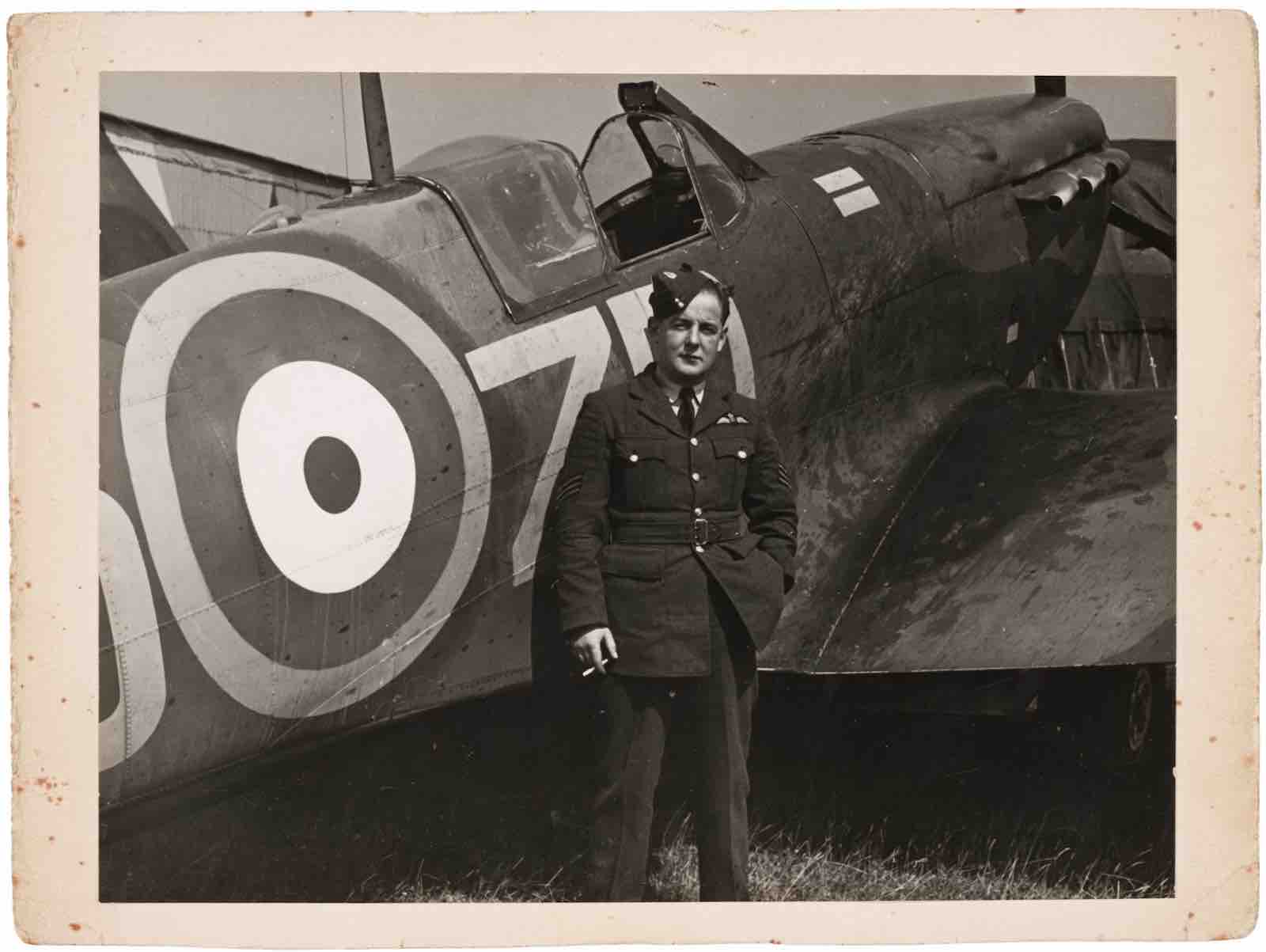 Baxter in RAF dress standing by his Spitfire